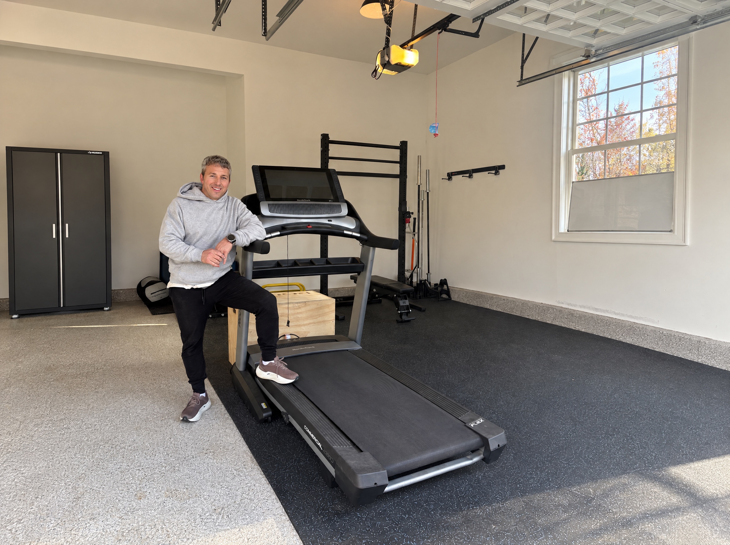 Oyster Bay Cove home gym with a treadmill, rack, and open training floor